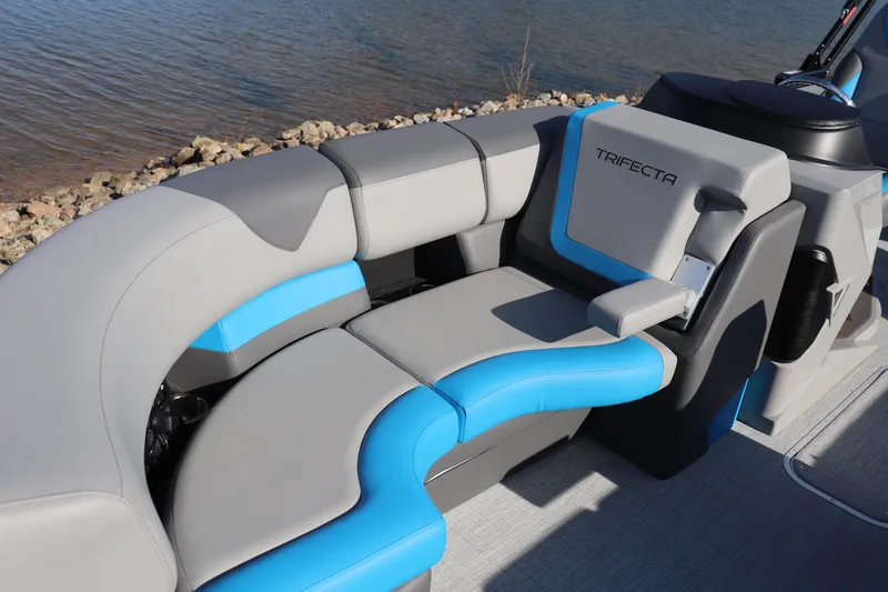 Slide: The Image of Luxurious seating on 2025 Trifecta 23 ULE pontoon boat, featuring gray and blue upholstery. - 2