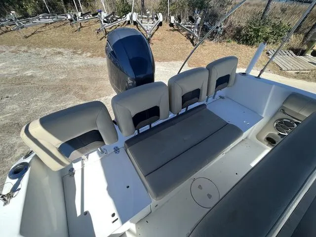 Slide: The Image of 2016 Hurricane CC 19 OB boat with seating and outboard motor, parked on land. - 11