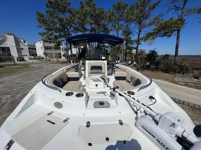 Slide: The Image of 2016 Hurricane CC 19 OB boat with seating, trees, and houses in the background. - 7