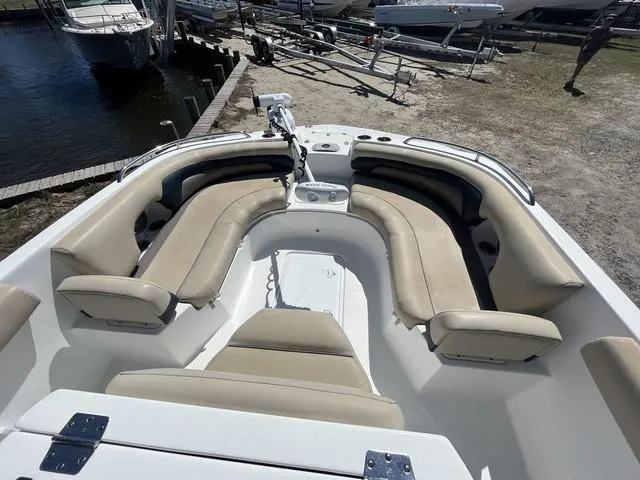 Slide: The Image of 2016 Hurricane CC 19 OB boat with beige seating, docked near water. - 8