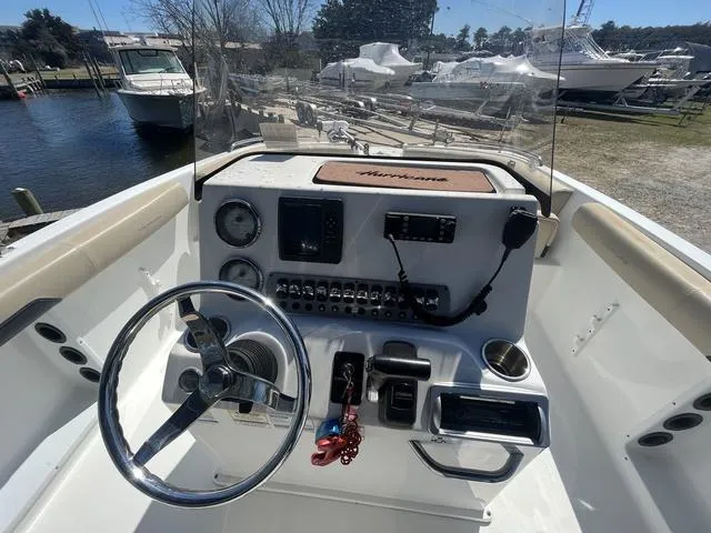 Slide: The Image of 2016 Hurricane CC 19 OB boat dashboard with steering wheel and controls. - 9