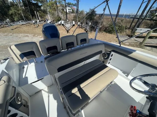 Slide: The Image of 2016 Hurricane CC 19 OB boat interior with beige seating and steering wheel. - 10