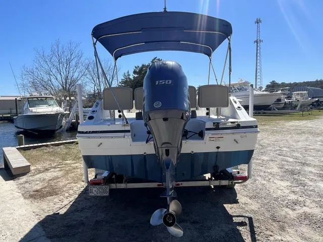 Slide: The Image of 2016 Hurricane CC 19 OB boat with outboard motor, parked on a trailer. - 5
