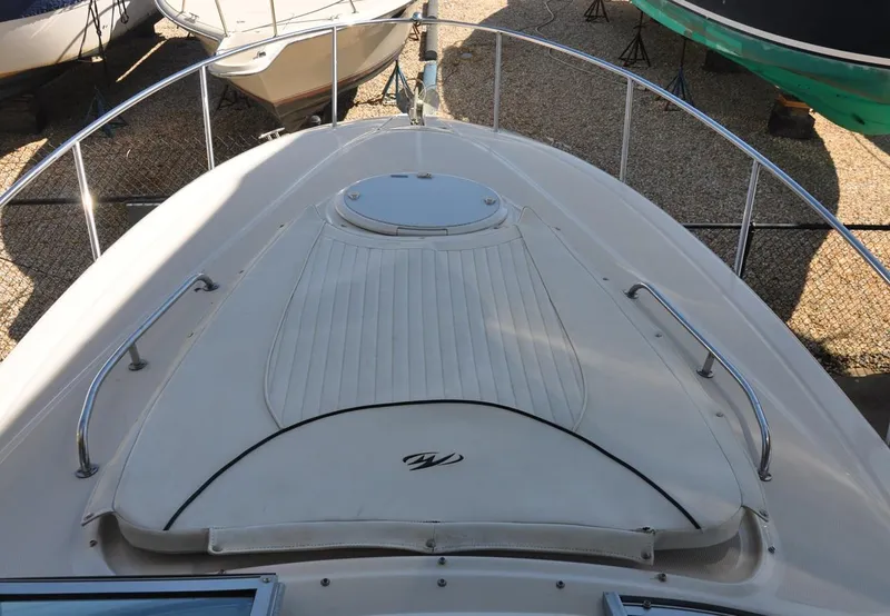 Slide: The Image of 2008 Monterey 270 Cruiser boat deck with railing and hatch, docked outdoors. - 10