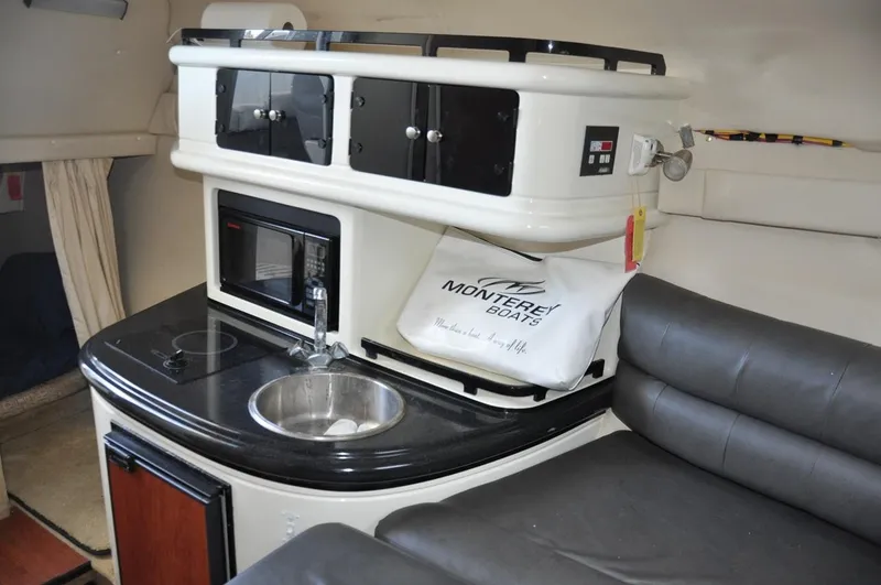 Slide: The Image of 2008 Monterey 270 Cruiser interior with kitchenette, sink, and seating area. - 18