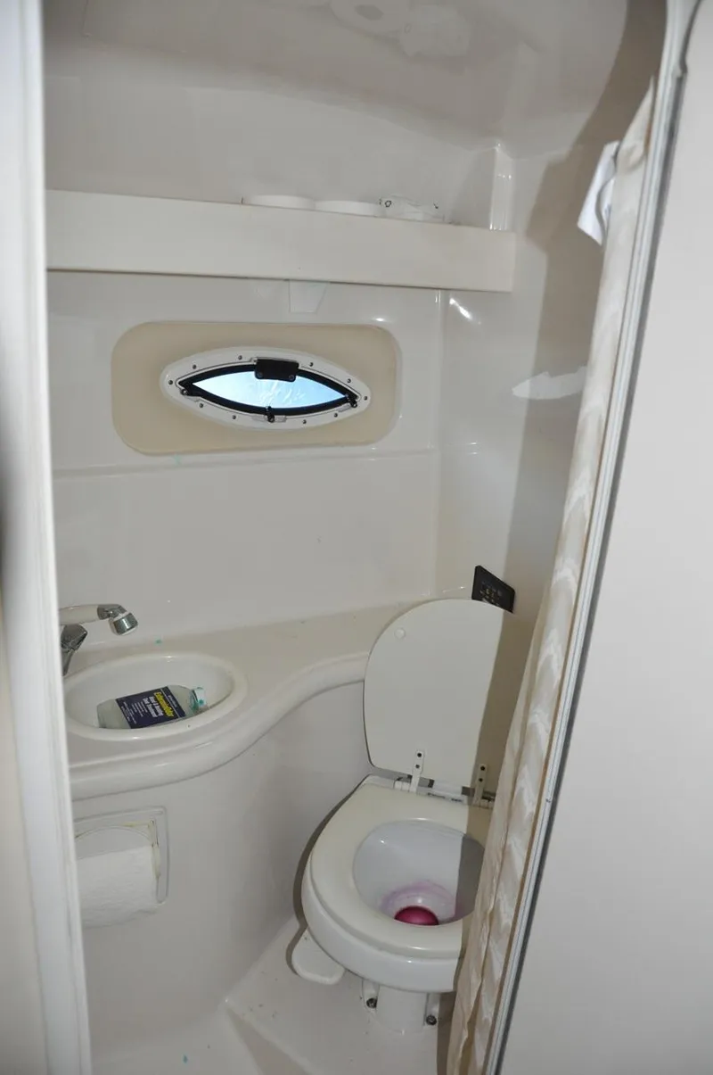 Slide: The Image of 2008 Monterey 270 Cruiser bathroom with sink, toilet, and porthole window. - 20