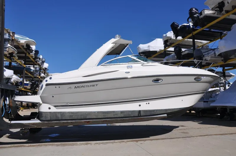Slide: The Image of 2008 Monterey 270 Cruiser boat in storage, side view, sunny day. - 3