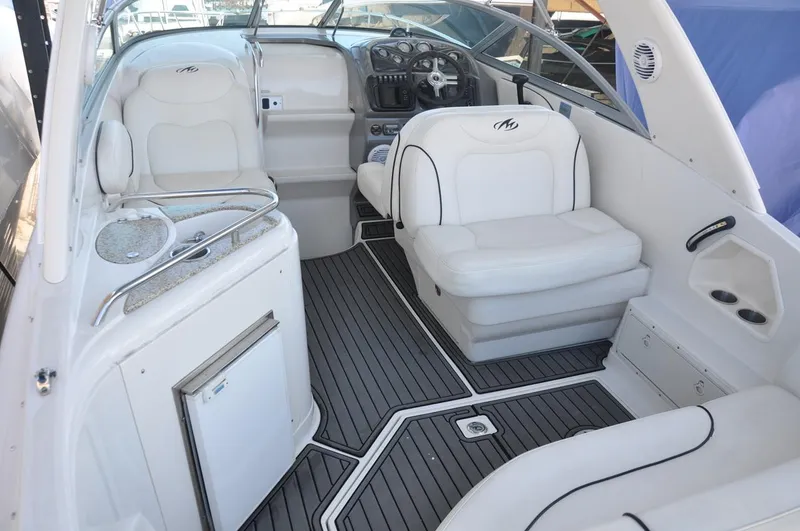 Slide: The Image of 2008 Monterey 270 Cruiser interior with white seating and modern dashboard. - 5