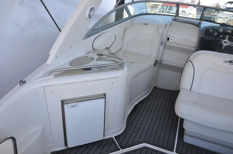 Slide: The Image of 2008 Monterey 270 Cruiser interior with white seating and sleek dashboard design. - 8