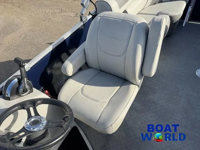 Slide: The Image of 2021 Starcraft EX 20 R Pontoon boat interior with steering wheel and comfortable seating. - 18