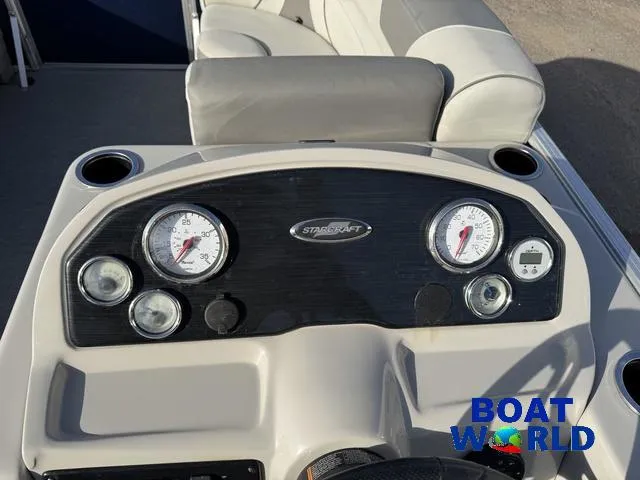 Slide: The Image of 2021 Starcraft EX 20 R Pontoon dashboard with gauges and controls, featuring "Boat World" logo. - 20
