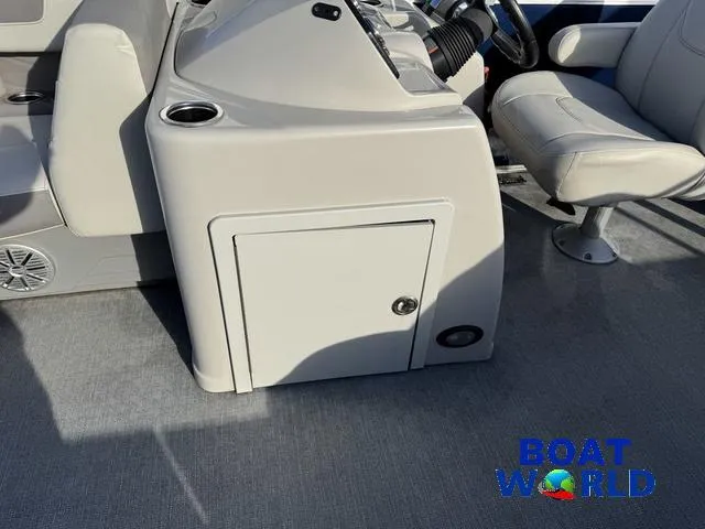 Slide: The Image of 2021 Starcraft EX 20 R Pontoon boat interior with steering console and seating. - 25