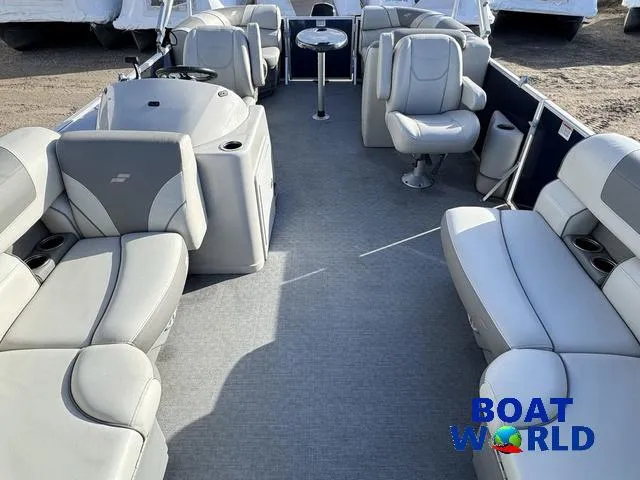 Slide: The Image of 2021 Starcraft EX 20 R Pontoon boat interior with gray seating and steering console. - 9