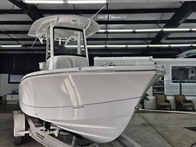 Slide: The Image of 2025 Regulator 24XO boat displayed indoors on a trailer. - 3