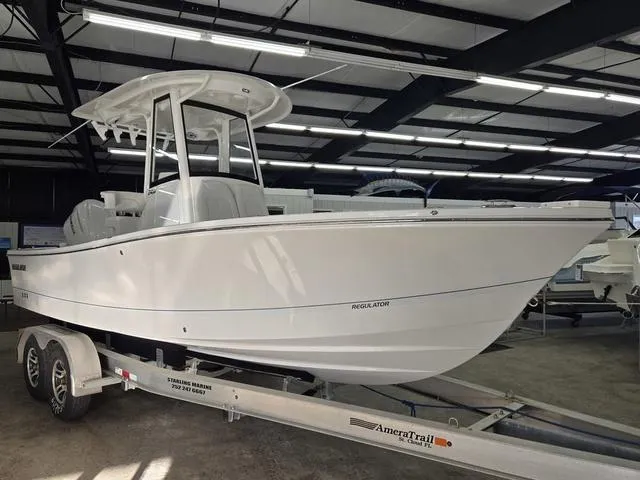 Slide: The Image of 2025 Regulator 24XO boat on trailer in indoor showroom. - 4