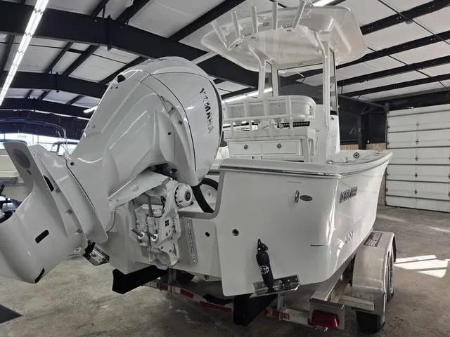 Slide: The Image of 2025 Regulator 24XO boat with Yamaha engine in a garage setting. - 5