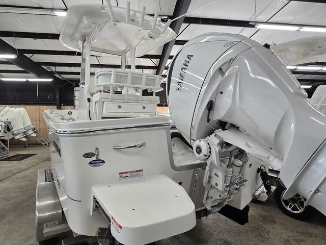Slide: The Image of 2025 Regulator 24XO boat with Yamaha outboard engine in a showroom. - 6