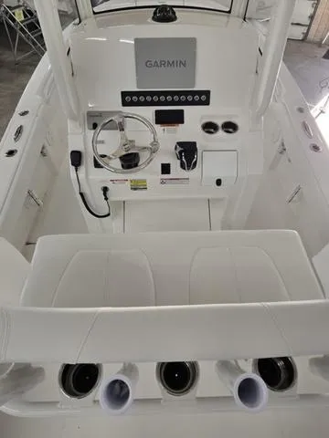 Slide: The Image of 2025 Regulator 24XO boat cockpit with Garmin navigation system and modern controls. - 7