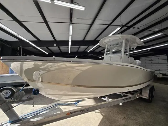 Slide: The Image of 2025 Regulator 26XO boat on trailer in a well-lit indoor storage facility. - 1