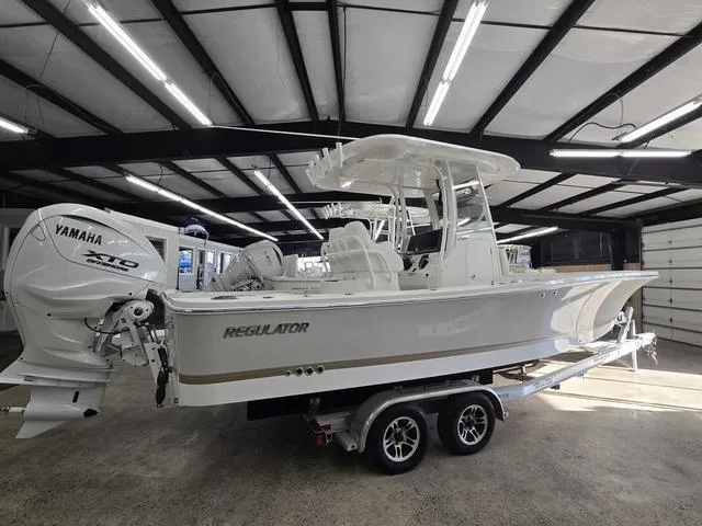 Slide: The Image of 2025 Regulator 26XO boat with Yamaha engine on a trailer in a well-lit garage. - 4