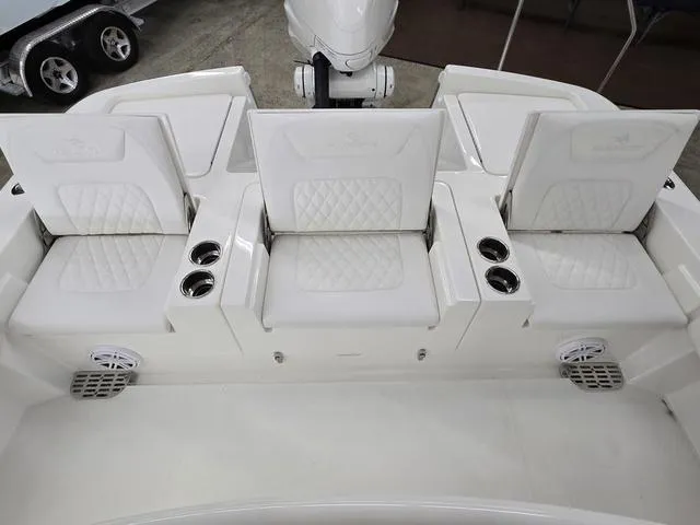 Slide: The Image of 2025 Regulator 26XO boat seating with cup holders and quilted cushions. - 6
