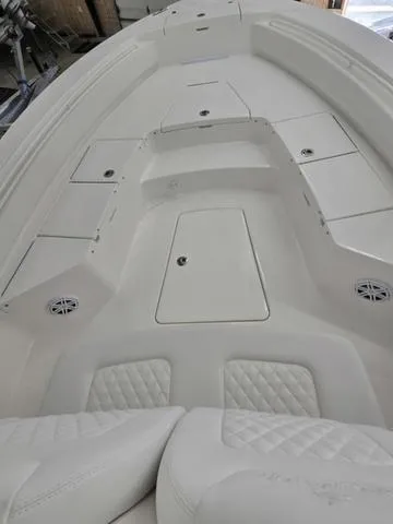 Slide: The Image of 2025 Regulator 26XO boat interior with white seating and storage compartments. - 8