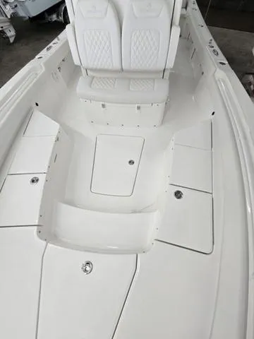 Slide: The Image of 2025 Regulator 26XO boat interior with white seating and storage compartments. - 9