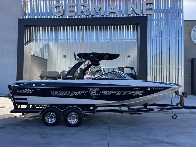 Slide: The Image of 2009 Malibu Wakesetter 23 LSV boat on trailer, parked outside Germaine dealership. - 1