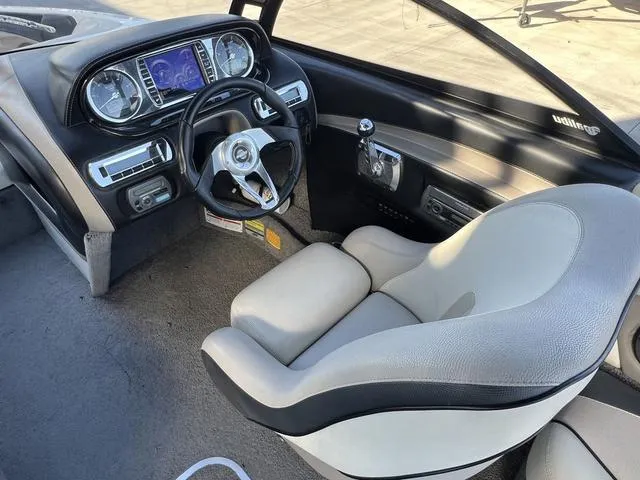 Slide: The Image of 2009 Malibu Wakesetter 23 LSV boat interior with steering wheel and dashboard controls. - 11