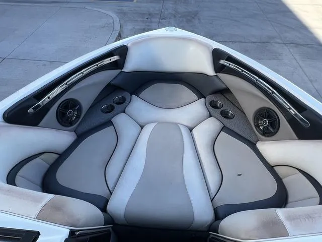Slide: The Image of 2009 Malibu Wakesetter 23 LSV boat interior with cushioned seating and built-in speakers. - 9