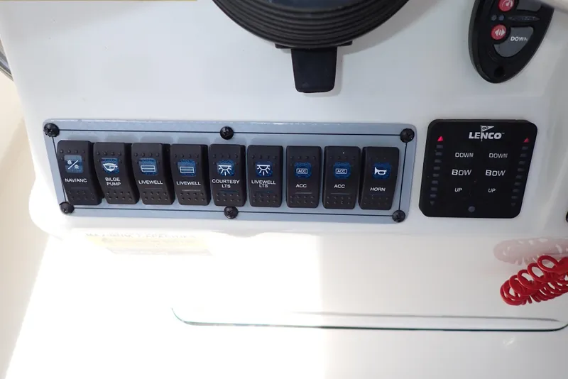 Slide: The Image of Control panel of 2022 Key West 188 Bay Reef boat with labeled switches and trim tab controls. - 13