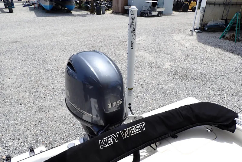 Slide: The Image of 2022 Key West 188 Bay Reef boat with Yamaha 115 outboard motor in a gravel lot. - 17