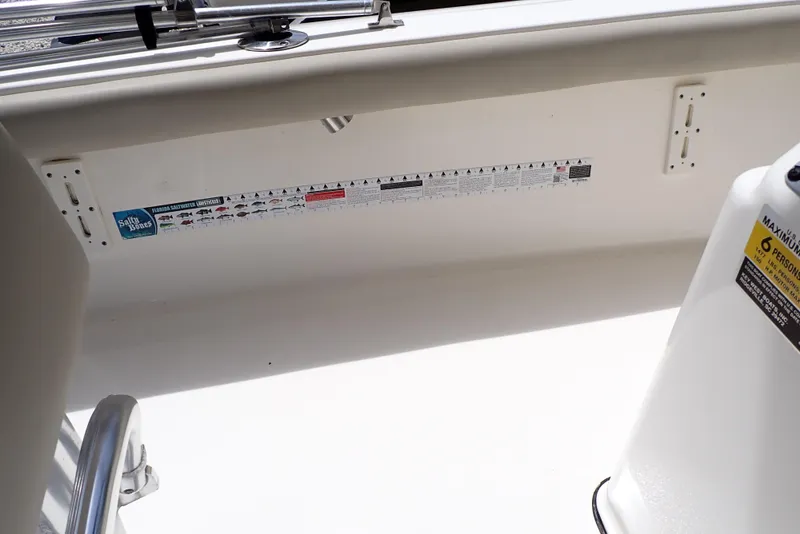 Slide: The Image of 2022 Key West 188 Bay Reef boat interior with measurement sticker and safety label. - 18