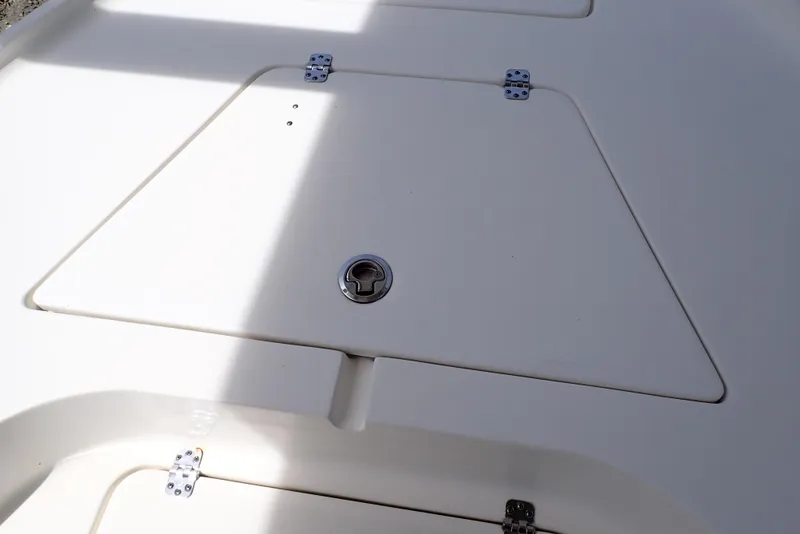 Slide: The Image of 2022 Key West 188 Bay Reef boat storage compartment with secure latch and hinges. - 22