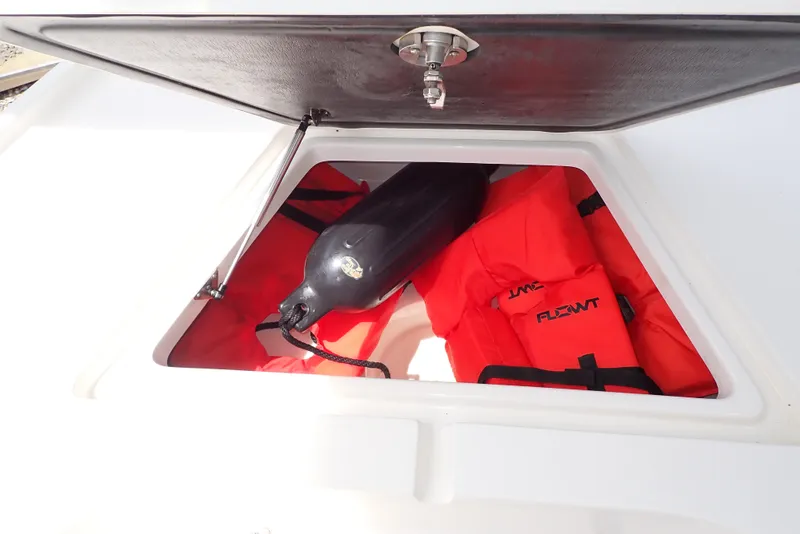 Slide: The Image of Open storage compartment on 2022 Key West 188 Bay Reef with life jackets and fender. - 23