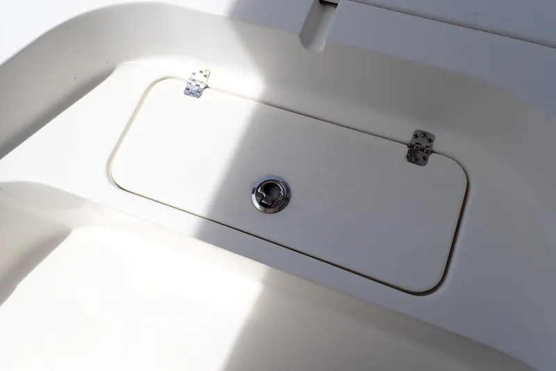 Slide: The Image of 2022 Key West 188 Bay Reef boat storage compartment with metal hinges and latch. - 24