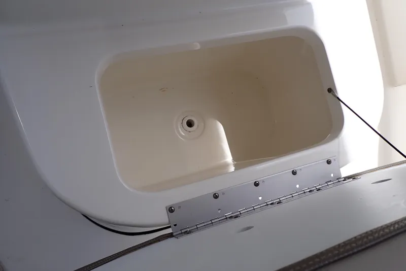 Slide: The Image of Key West 188 Bay Reef 2022 boat compartment, open and empty, with visible hinge. - 27