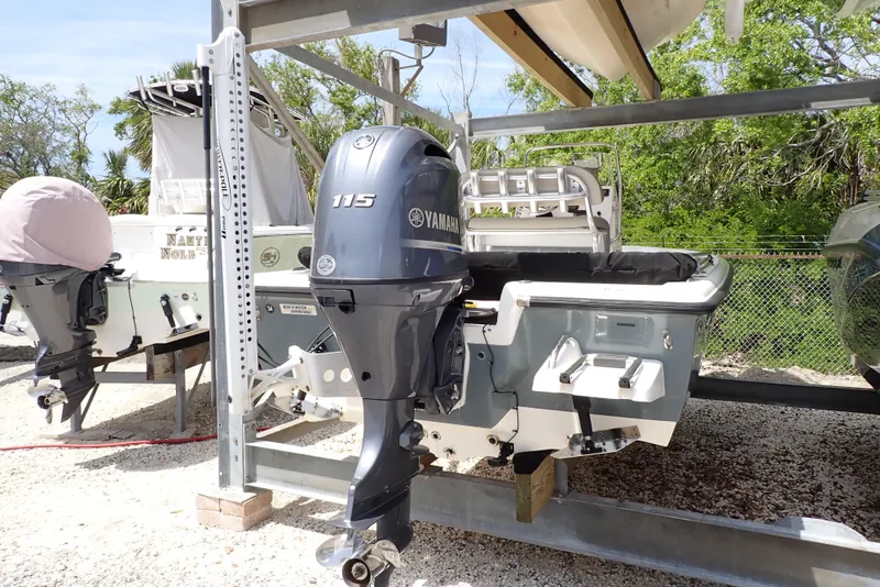 Slide: The Image of 2022 Key West 188 Bay Reef boat with Yamaha 115 outboard motor on a rack. - 3