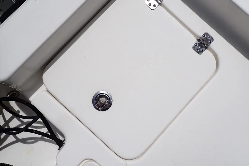 Slide: The Image of 2022 Key West 188 Bay Reef boat storage compartment with metal latch and hinges. - 34