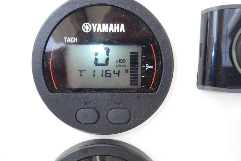 Slide: The Image of Yamaha tachometer displaying 0 RPM and 1164 hours on a 2022 Key West 188 Bay Reef. - 4