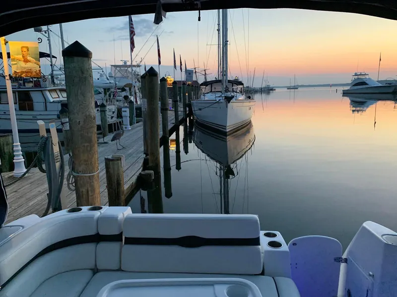 Slide: The Image of 2018 Rinker EX 270 docked at serene marina during sunset. - 12