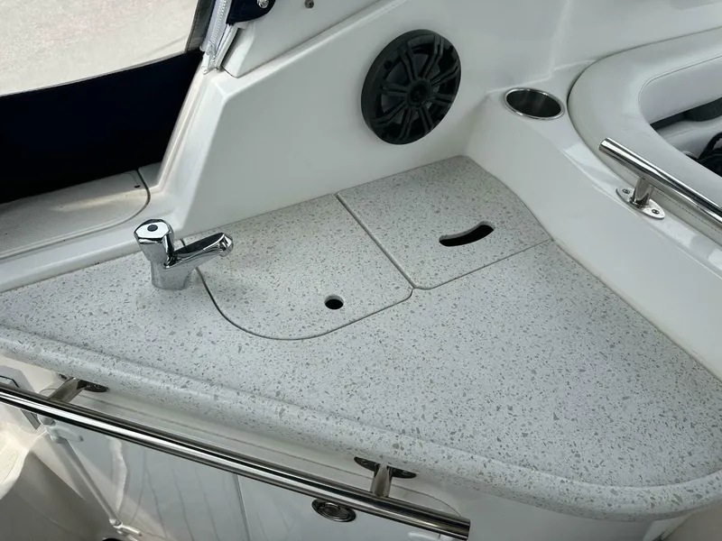 Slide: The Image of 2018 Rinker EX 270 boat interior with sink and countertop. - 19