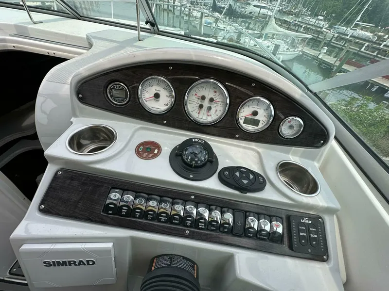 Slide: The Image of Control panel of a 2018 Rinker EX 270 boat with gauges and switches. - 21