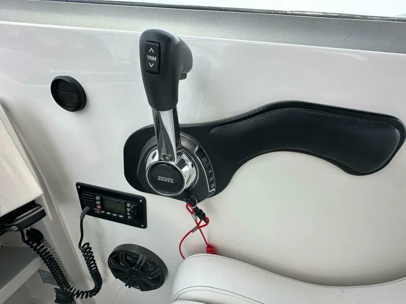 Slide: The Image of Throttle control panel of a 2018 Rinker EX 270 boat with trim adjustment. - 24