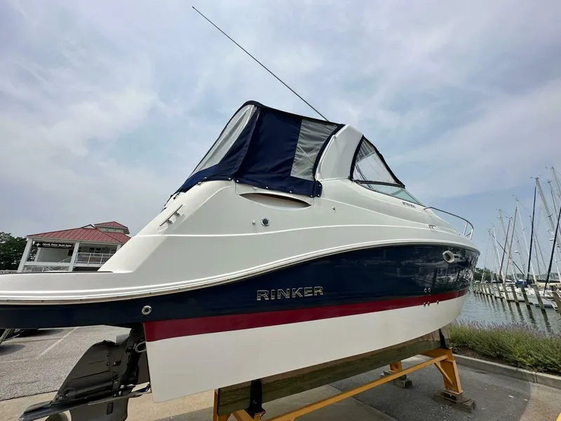 Slide: The Image of 2018 Rinker EX 270 boat on display at a marina. - 26