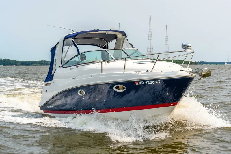 Slide: The Image of 2018 Rinker EX 270 boat cruising on open water. - 3