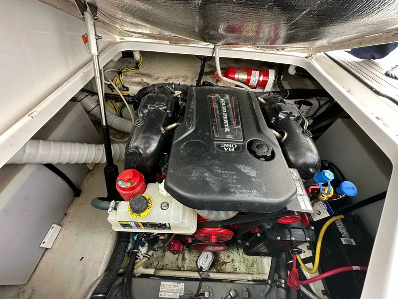 Slide: The Image of Engine compartment of a 2018 Rinker EX 270 boat, featuring a V8 engine. - 34