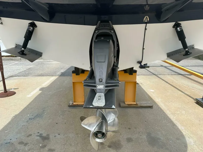 Slide: The Image of 2018 Rinker EX 270 boat stern with propeller and trim tabs on display. - 35
