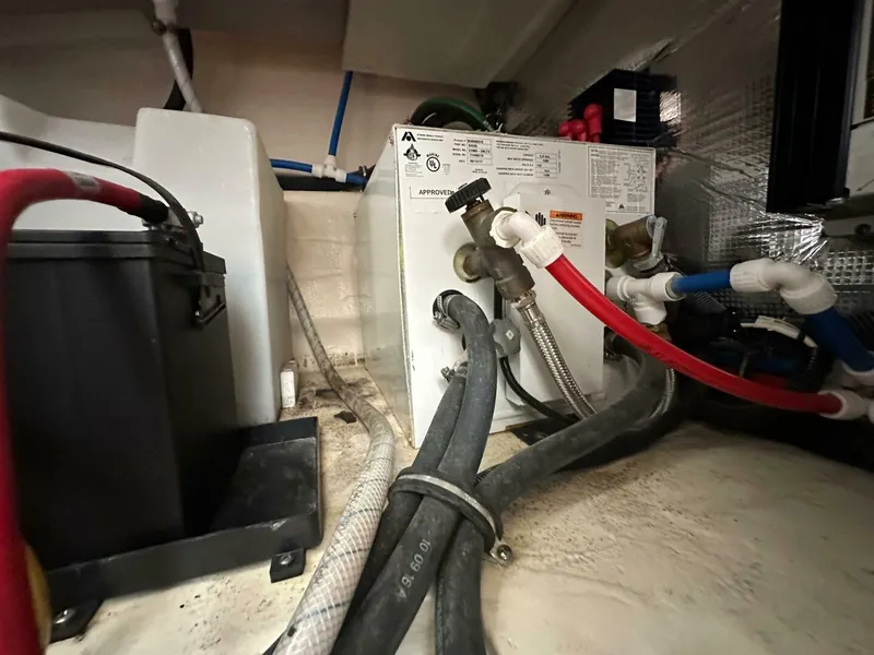 Slide: The Image of Engine compartment of a 2018 Rinker EX 270 boat, showing hoses and equipment. - 37