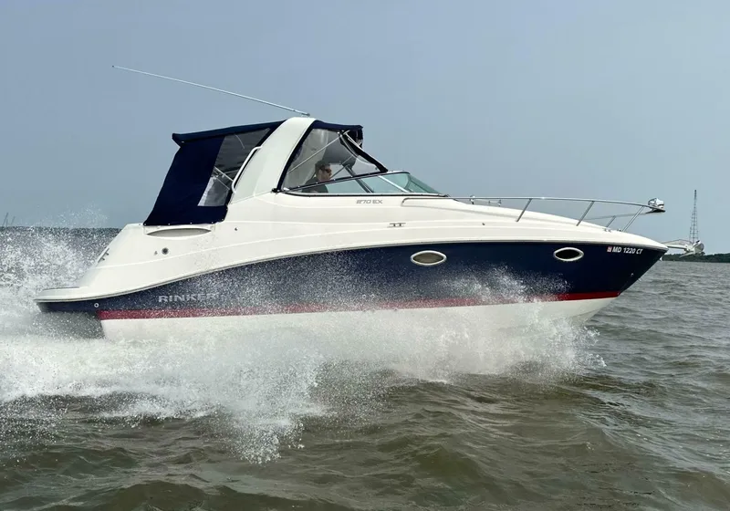 Slide: The Image of 2018 Rinker EX 270 boat cruising on open water. - 4